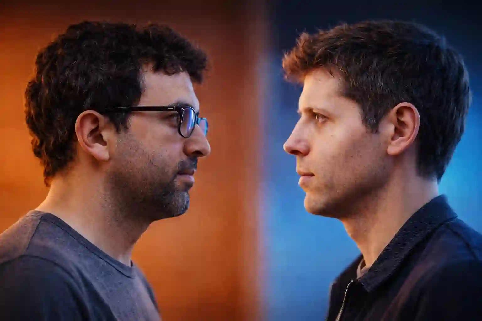 Two AI lab leaders facing each other, one lit orange and one lit blue